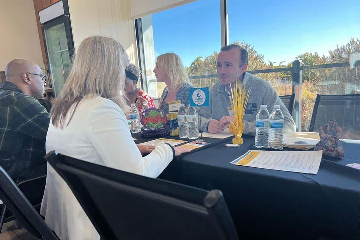 Discussion between convention attendants seated at a table inside